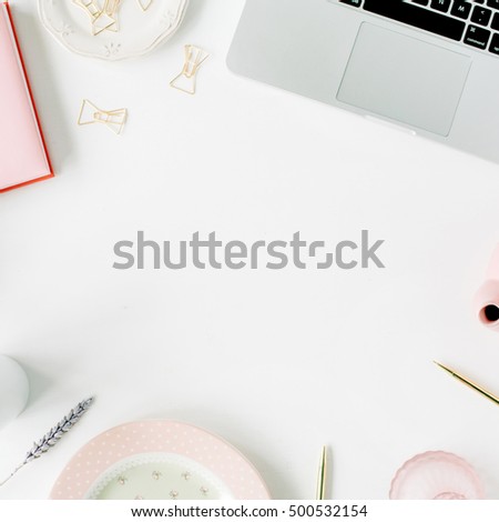 Flat lay fashion feminine home office workspace. Laptop, pink teapot, diary, golden pen and clips. Top view