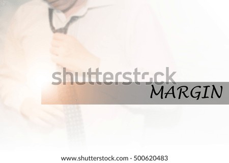 Hand writing MARGIN with the young business man on background. Business concept. Stock Photo.