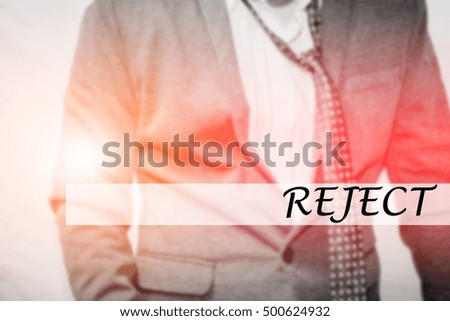 Hand writing REJECT with the young business man on background. Business concept. Stock Photo.