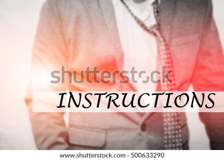 Hand writing INSTRUCTIONS with the young business man on background. Business concept. Stock Photo.