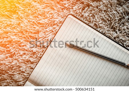 Vintage Book with Blank Pages as Copy Space on the New Beige Carpet Floor, top view CREATIVITY IDEAS CONCEPT WITH FREE COPY SPACE