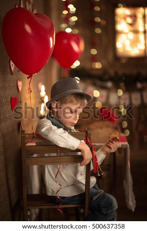 a boy at table in the cafe, concept valentines day, dark background, candle