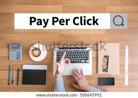 PPC - Pay Per Click concept Businessman working with financial reports and a laptop with other objects around, coffee,  top view