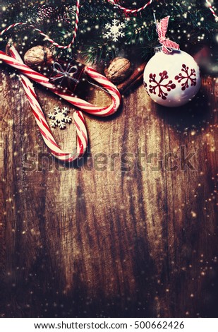 Vintage Christmas Card  with Christmas decoration and snow over wooden background

