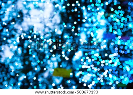Holiday blur abstract. White and blue illumination off focus background.