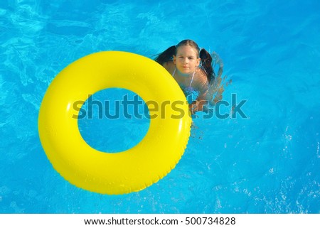 Real toddler girl at swimming pool, summer vacation concept