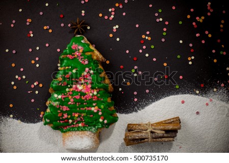 Still life with christmas tree cake decorated with green icing and star anise