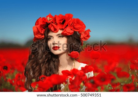 Beautiful hair, happy smiling teen girl portrait with red flowers on head enjoying in red poppies field nature over blue sky background.