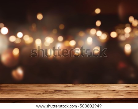Festive background with light spots and bokeh in front of a empty wooden table