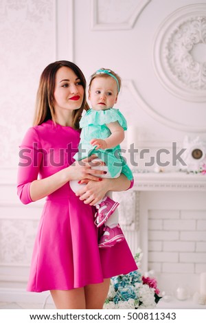 Mother and baby closeup portrait, happy faces, european family picture, adorable small girl, mom and kid having fun indoor, parents joy, holding little child, healthy toddler and mommy, 