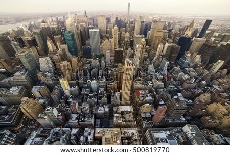 Manhattan up town aerial view from skycarpenter in warm light of sunset Royalty-Free Stock Photo #500819770
