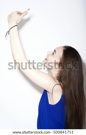 Girl in blue dress taking a selfie