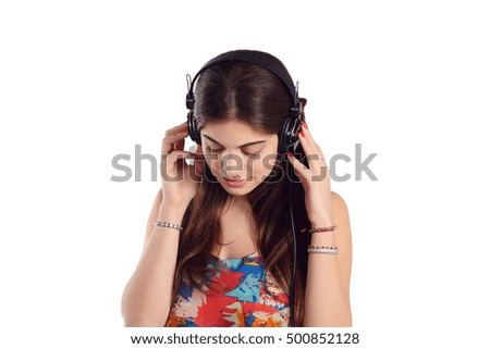 Young beautiful woman listening to music indoor. Isolated white background.
