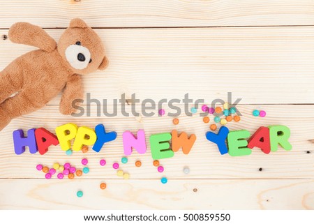 happy new year colorful with toy on wood background