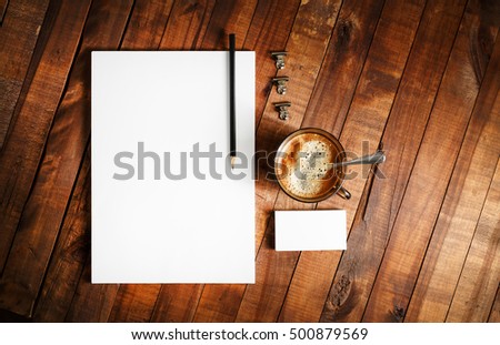 Photo of blank stationery on vintage wooden table background. Responsive design mock up. Template for your design.