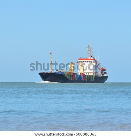 Cargo ship sailing in blue sea to the port of Antwerpen, Belgium