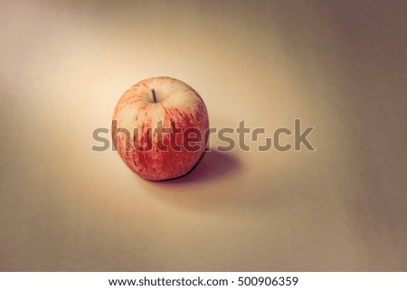 sunlight red apple on the paper background,vintage image