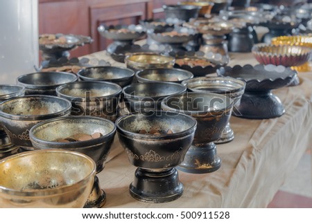 Many coins in the tray so the monks to make merit
