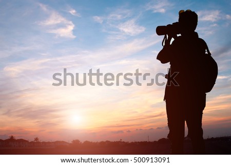 Photographer shooting sunset sky