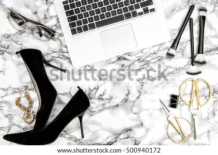 Feminine accessories, notebook, shoes, office supplies on bright marble table background. Fashion flat lay for blogger social media