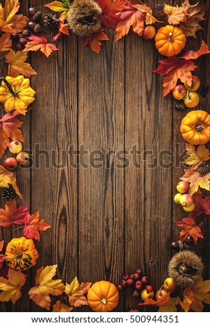 Vintage border from fallen leaves and fruits on the old wooden table. Thanksgiving autumn background
