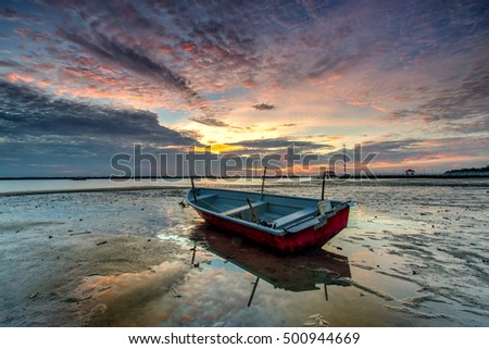 Beautiful A long exposure picture of  sunset over a fishing boat