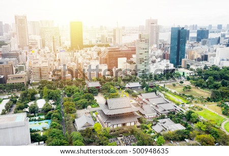 Business and culture concept - panoramic modern city skyline bird eye aerial view with zojo-ji temple shrine from tokyo tower under dramatic sunrise and morning blue sky in Tokyo, Japan