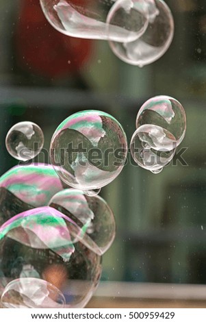 London, UK - July 2016:  Bubbles from a street entertainer, with St Paul's Cathedral in the background, on the South Bank London