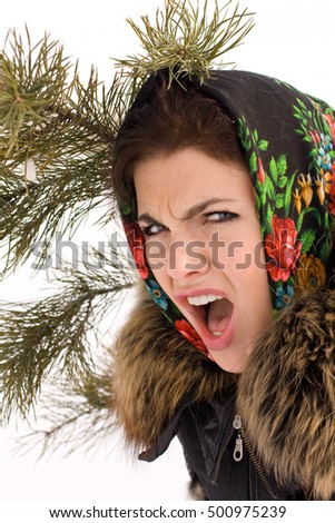 Portrait of young pretty funny smiling girl in cold weather dressed in leather coat with a fur collar and warm national scarf. Young happy woman having fun outdoors.