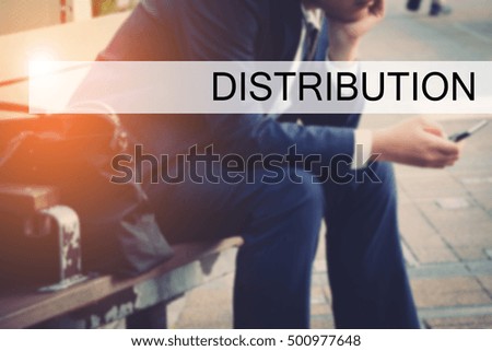 Hand writing DISTRIBUTION with the young business man on background. Business concept. Stock Photo.