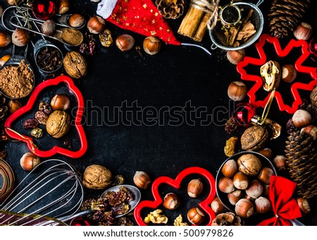 Christmas New Year Holiday baking background with ingredients, spices, nuts, cookie cutters, fir tree cones and christmas decoration