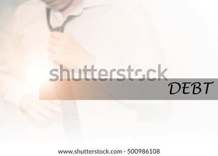 Hand writing DEBT with the young business man on background. Business concept. Stock Photo.