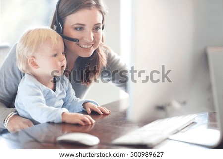 Mother and baby boy looking at computer