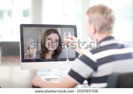 Man toasting wife using video call