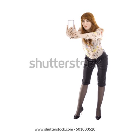 Young attractive redhead woman taking selfie with smartphone- studio shot - isolated white - copy space