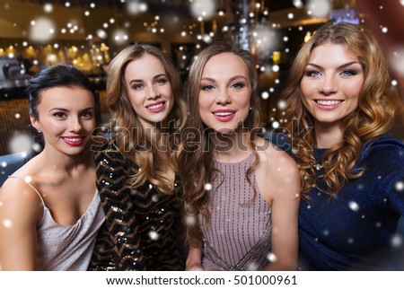 friends, bachelorette party, technology and holidays concept - happy smiling young pretty women taking selfie at night club