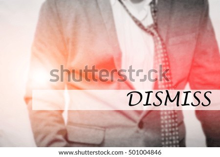Hand writing DISMISS with the young business man on background. Business concept. Stock Photo.