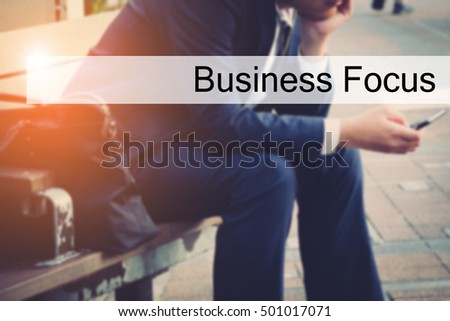 Hand writing Business Focus with the young business man on background. Business concept. Stock Photo.