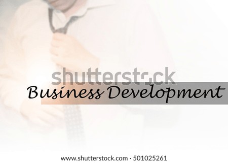 Hand writing Business Development with the young business man on background. Business concept. Stock Photo.