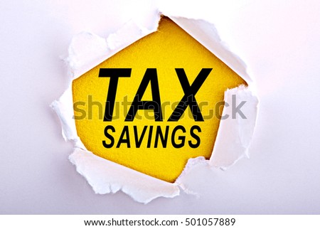 Words Tax savings on ripped paper - Business, technology, internet concept. Stock Photo
