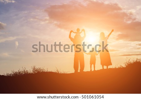 Happy family dancing on the road in the sunset time. Evening party on the nature
