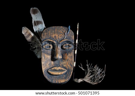 decorative mask with feather of warrior on a black background handmade. Mask of the American Indian