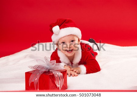 Beautiful little baby celebrates Christmas. New Year's holidays. gift