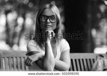 Thoughtful girl sitting on outdoor terrace.black - white photo