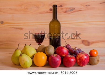 fruits and wine on wooden table, studio picture