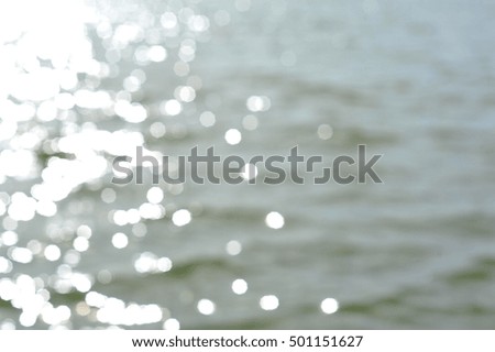 white bokeh of sunlight on water surface from blur focus