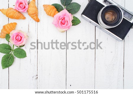 Vintage Camera, Instax Photos and Croissant on White Wooden Background, Flat Lay Style with Free Text Space