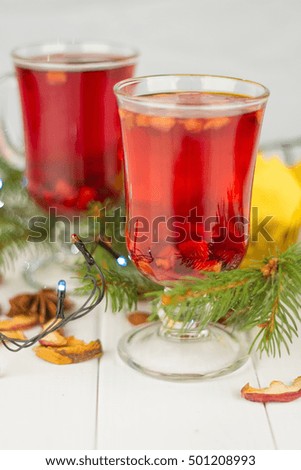 Hot winter drinks. Red tea cinnamon star anise seeds by fir needles