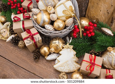 Christmas or New Year background: fur-tree, branches, gifts, colored glass balls, decoration and cones on wooden background