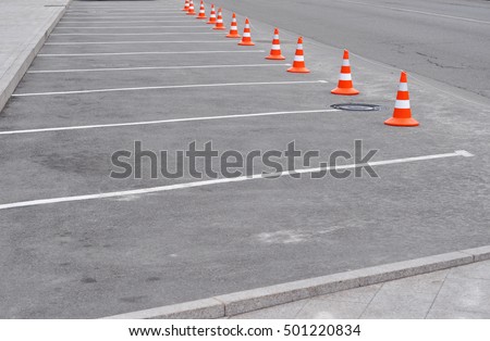 Car parking lot with white mark and traffic cone on street used warning sign on road. Traffic Cones - Road Safety Cones